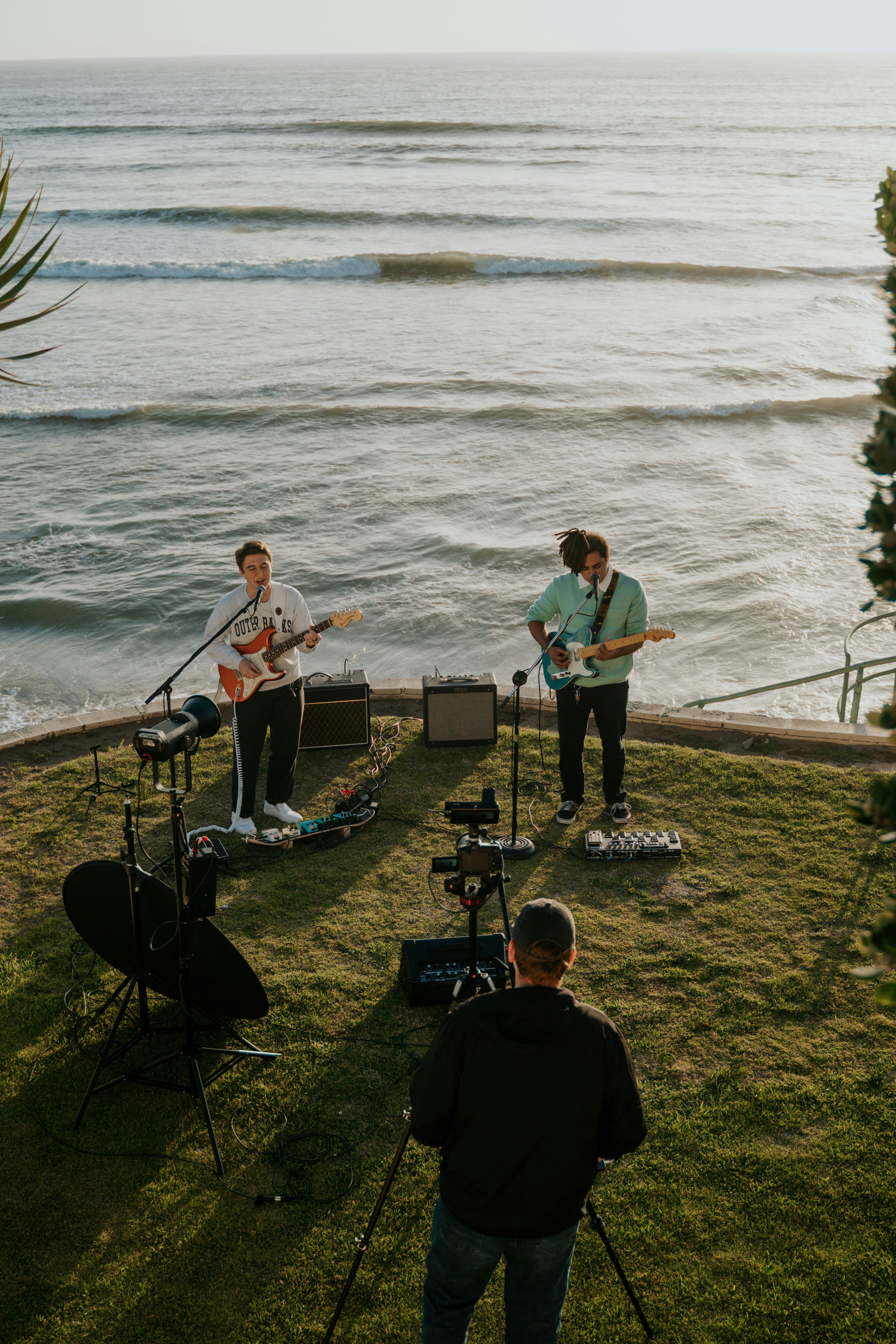 man in blue crew neck t-shirt playing guitar